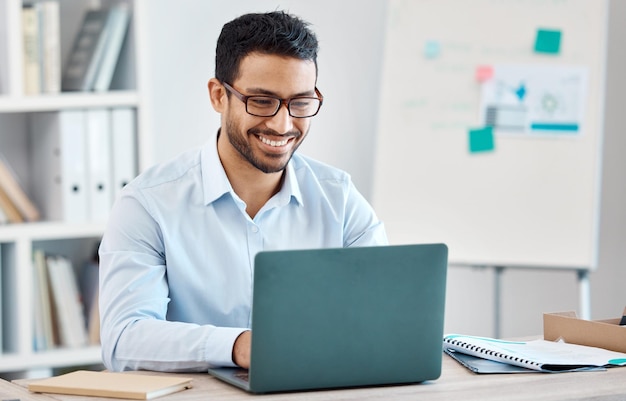 Business man typing on laptop research or working on marketing accounting or data Corporate person on computer or reading writing email or planning a finance project in the office with a smile