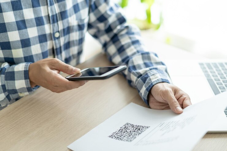 Photo business man use phone to scan barcode or qr codes to pay credit card bill after receiving document invoice online payment receive paying electricity digital payments without money technology