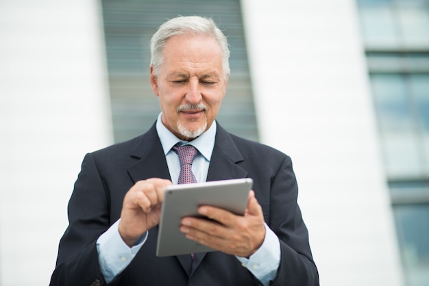 Business man using his tablet outdoor