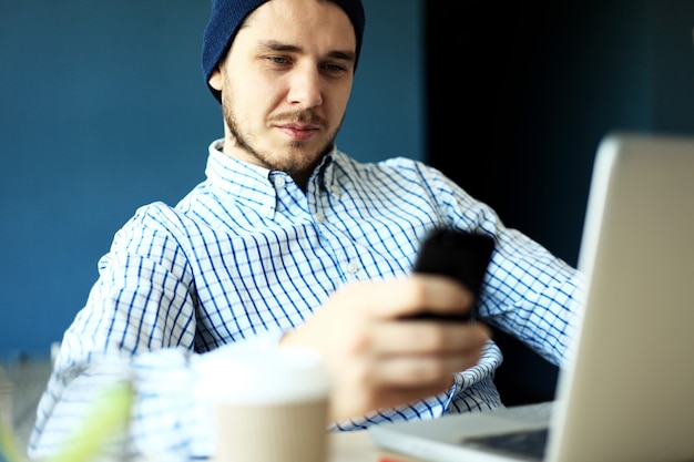 Business man using internet on smart phone and laptop