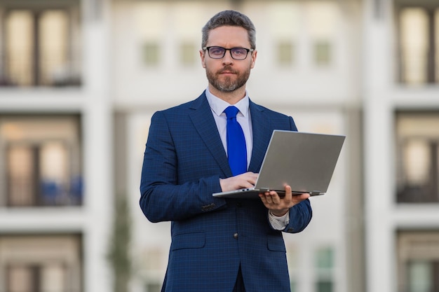 Business man using laptop outside male businessman worker hold computer laptop front of home man usi