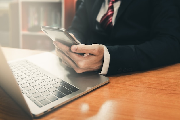 Business man using smart phone and laptop