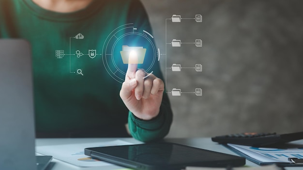 Business man with holograms of digital document files data files on computers stored as cloud databases can be viewed online and prevented data loss from the device Data file management concept