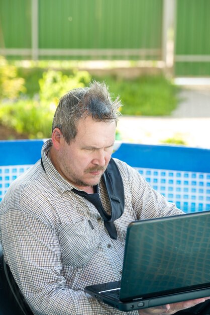 Business man with a laptop working in the pool