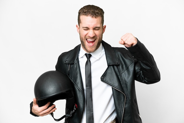 Business man with a motorcycle helmet over isolated white background celebrating a victory