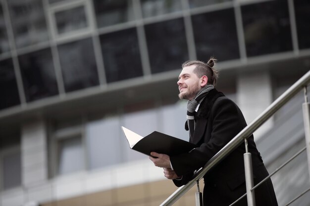 Business man with papers comes into his office