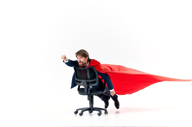Business man with red cloak trying in superman office chair. high quality photo