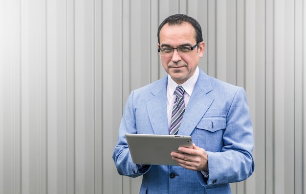 Business man with a tablet in his hands.