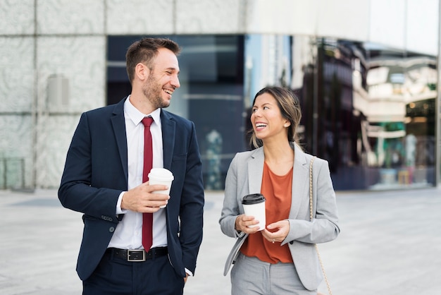 Business man and woman colleagues having a coffee break talking together