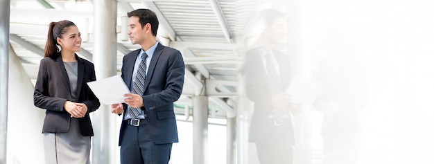 Business man and woman discussing work on the go