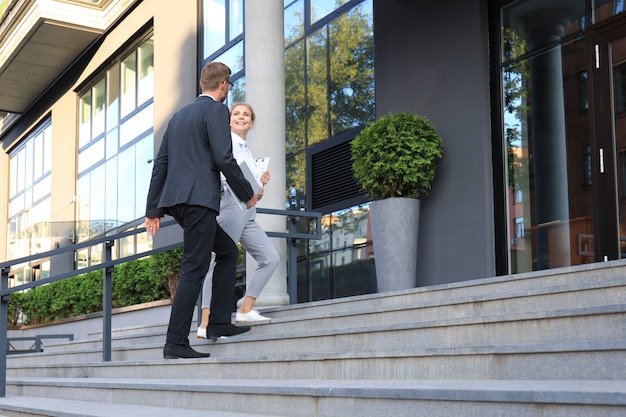 Business man and woman walking in the office center.