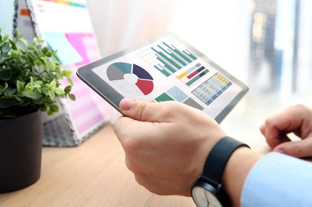 Business man working and analyzing financial figures on a tablet