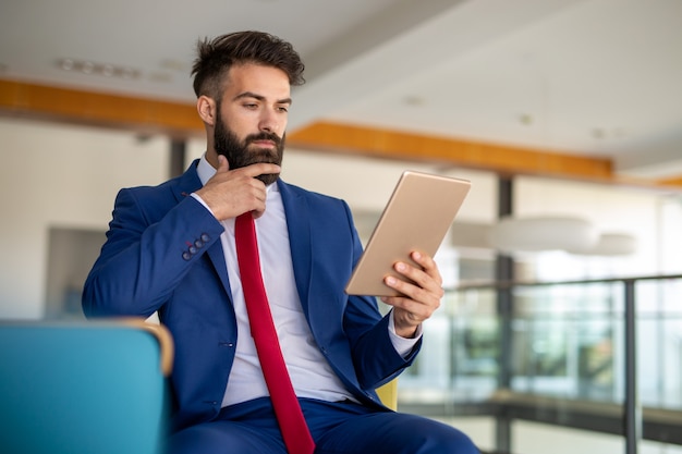 Business man working on his tablet in the office