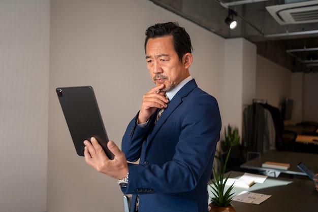 business man working on ipad side view