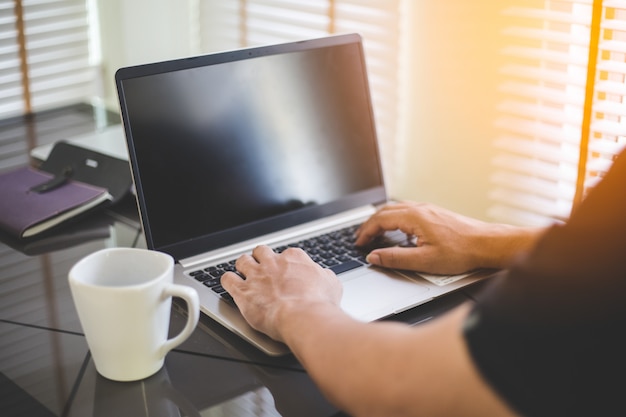 Photo business man working on laptop,young man uses technology