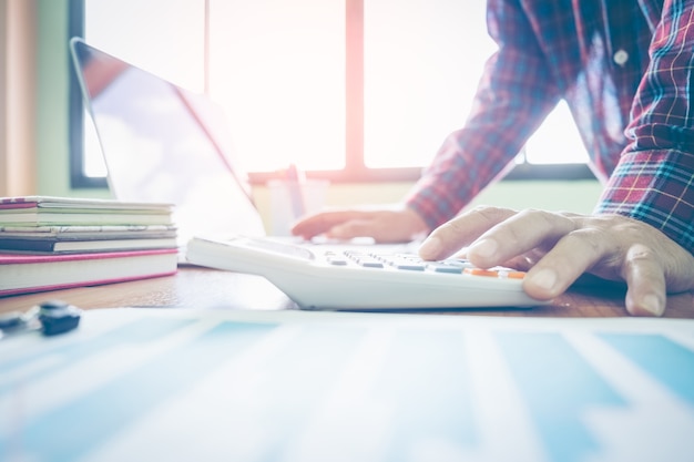 Business man working at office with calculator and documents