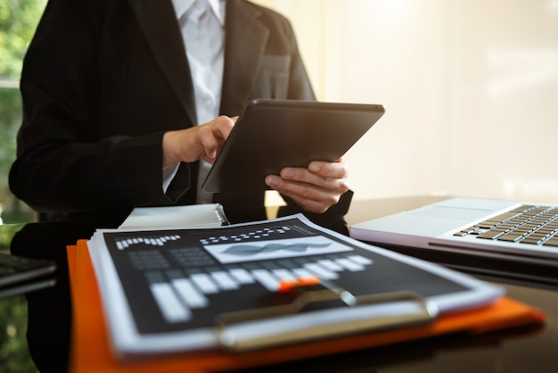 Business man working at office with laptop and documents on his desk new start up project. Finance task.