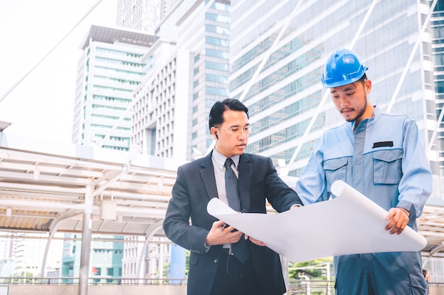 Business manager and engineer meeting project at construction site