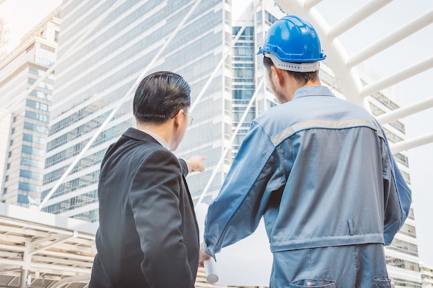 Business manager and engineer meeting project at construction site