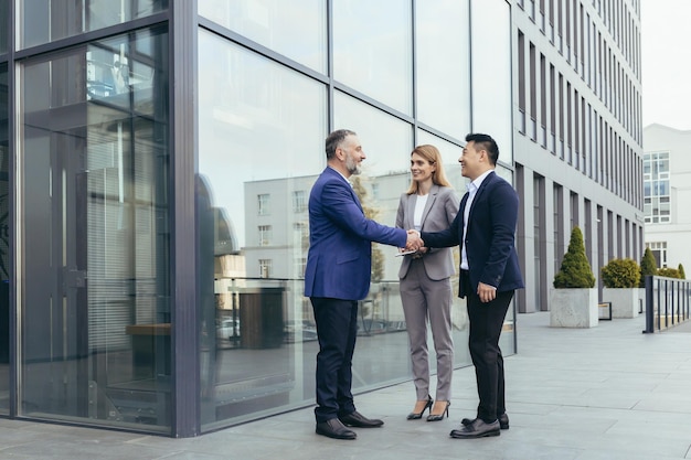 Business meet colleagues happy team meet outside office greet shake hands diverse employees in