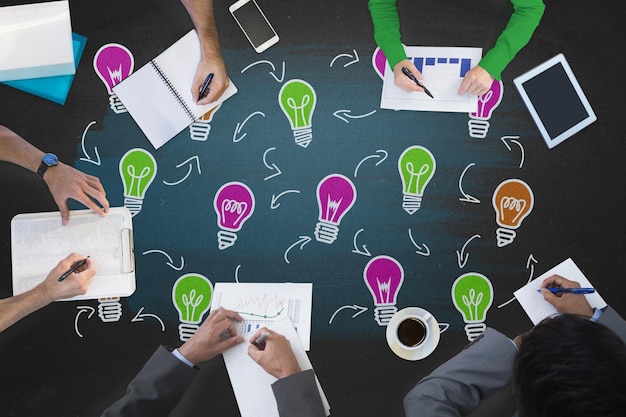 Business meeting against light bulbs