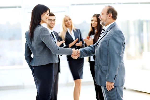 Business meeting business partners in an office with a handshake