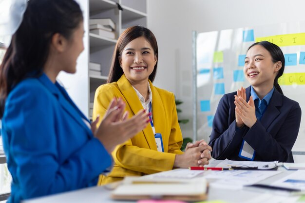business meeting employees are applauding congratulating and motivation their coworkers conference presenting successful business ideas in the office
