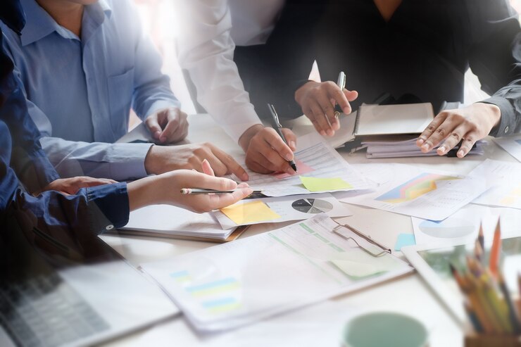 Photo business meeting on table with tablet computer and paper document in office workplace.