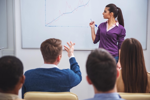 Business meeting Teamwork concept Young business woman with speech to colleagues