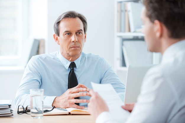 Business meeting. Two business people sitting in front of each other in the office 