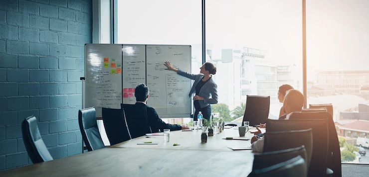 Photo business meeting whiteboard and woman speaker with presentation in office for planning schedule or project management leadership coaching and manager hand pointing to objectives note or priority