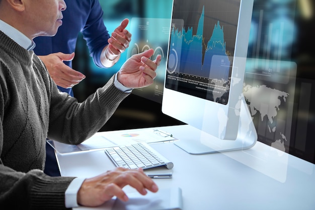 Business men looking into a modern computer screen reviewing a financial report