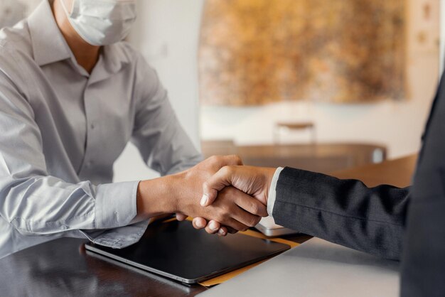 Business men shake hands confidently at an office meeting