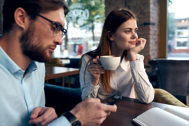 Business men and woman sitting in a cafe a cup of coffee leisure communication