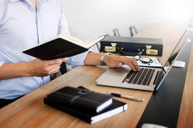 business men working on wooden desk(table) with notebook computer paper