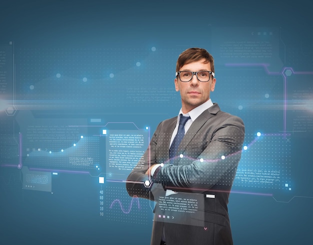 business, new technology and office concept - attractive buisnessman or teacher in glasses with charts on virtual screen