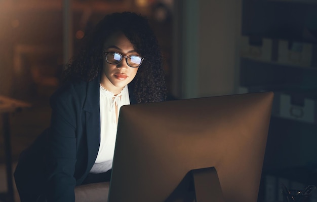 Business office and black woman on computer at desk for project strategy report and reading email Corporate manager overtime and female standing done working on schedule planning and research