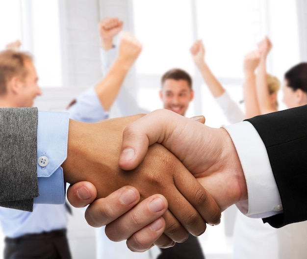 business and office concept - businessman and businesswoman shaking hands