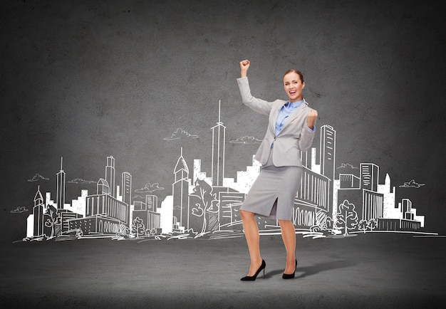 business and office concept - young happy businesswoman with hands up