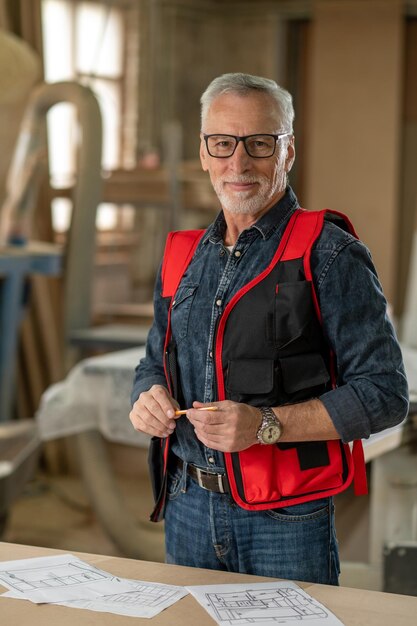 Business owner. Good-looking mature man in a carpentry workshop