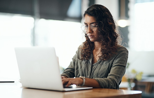 Premium Photo | Business owner typing on laptop checking emails and ...