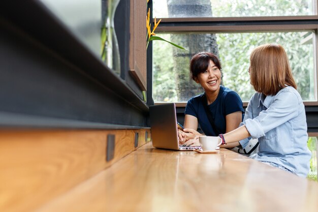 ビジネスオーナーの女性は、アイデアを話し、カフェに座って意見を共有する。