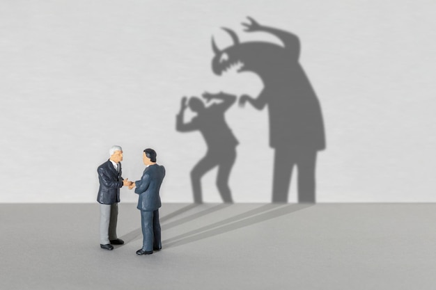 Business partner monster Businessmen shake hands but the shadow indicates that one monster