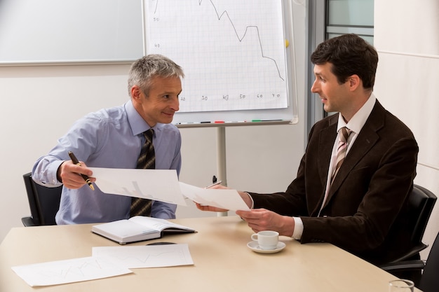 Business partners are discussing a successful project meeting bosses in the office