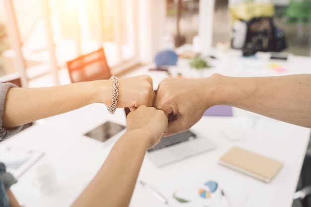 business partners giving fist bump to complete mission successful deal together 