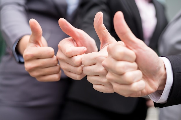 business partners keeping thumbs up