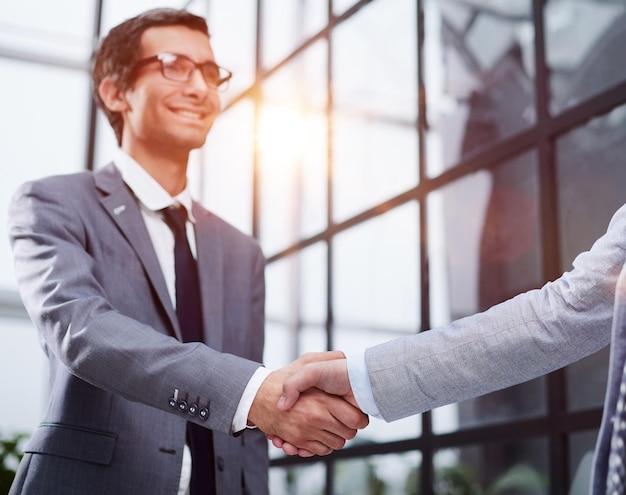 Business partners shake hands in the office