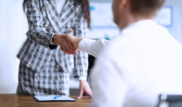 Business partners shaking hands after making good deal