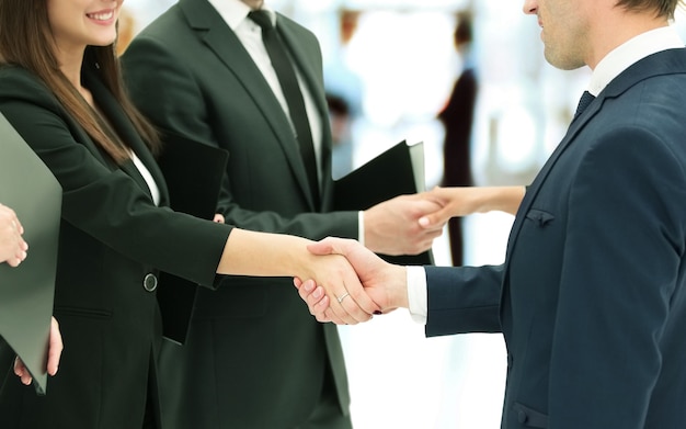 business partners shaking hands after signing of the contract