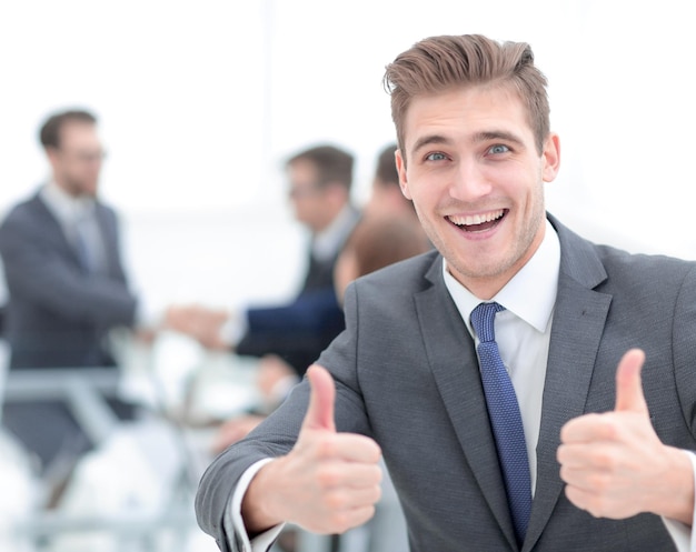 Business partners shaking hands over business objects on workplace